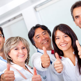 Group of doctors with thumbs up at the hospital